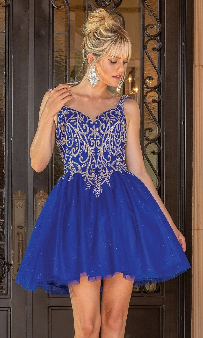 A woman wearing the Embroidered-Bodice Short Glitter Hoco Dress 3295, featuring a blue lace-up back and intricate silver embroidery, stands before ornate double doors.